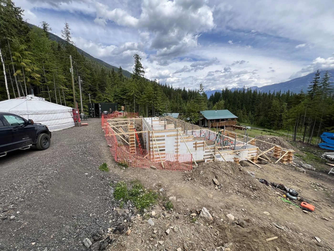 Foundation walls formed up on a hillside site with mountains behind